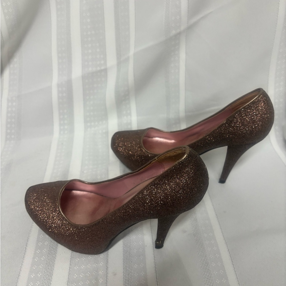 Brown high heel shoes with a classic pump style and a glittery finish